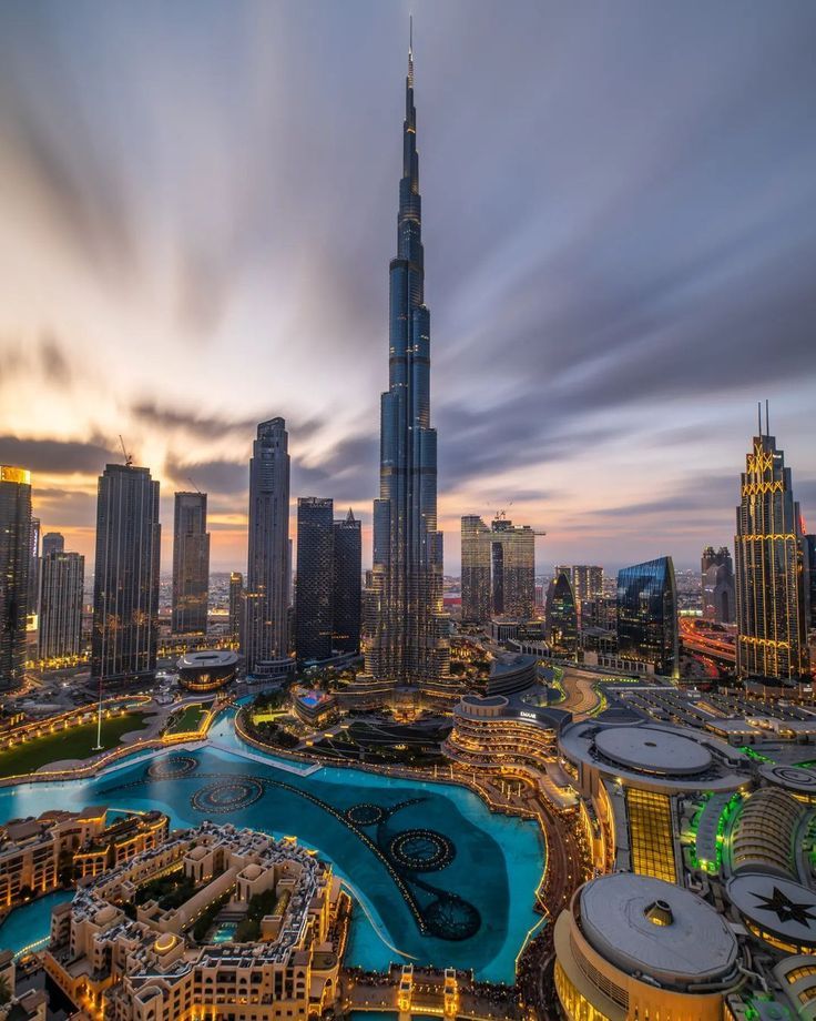 an aerial view of the burj tower and surrounding buildings at dusk in dubai, united kingdom