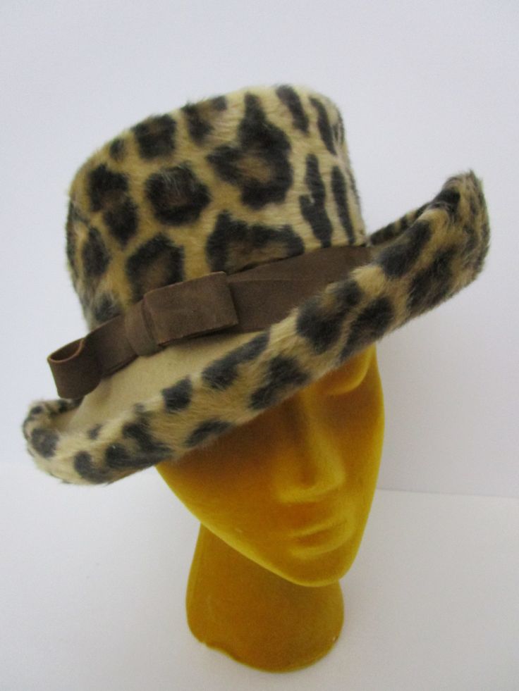 "Super soft plush vintage hat with printed leopard spots. Top of medium brim is khaki tan wool felt. Dark brown suede bow band.  Posable and packable. Choosing vintage is a simple sustainable way you can reuse recycle repurpose for a healthier Mother Earth.  Condition:  Very good vintage condition, slightest wear, slight misshape. See photos. Size:  Smaller size. Measures 21-1/2\" inside tan grosgrain ribbon circumference, 13\" inside diameter, 3-1/2\" brim at front, 3-3/4\" tall at center back. Please email any questions you may have.  Follow us on Instagram: https://www.instagram.com/fabulousvintagehats/ And on Facebook: https://www.facebook.com/Fabulousvintagehats/ Take a peek at my other millinery beauties here: https://www.etsy.com/shop/FabulousVintageHats?section_id=10867829&ref=shop Vintage Felt Hat With Flat Brim For Fall, Vintage Flat Brim Felt Hat For Fall, Vintage Fur Felt Hat For Fall, Adjustable Vintage Felt Hat For Fall, Vintage Fedora Hat For Winter, Vintage Fedora For Winter, Retro Wide Brim Cloche Hat For Winter, Vintage Beige Felt Hat For Winter, Vintage Wide Brim Hat For Fall