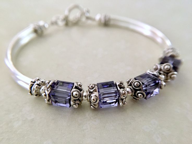 This comfortable bangle bracelet is so pretty in person. Perfect for your bridesmaids on your special wedding day! Can also be given for an anniversary, birthday or mothers day gift among many others... Choose from many colors from the dropdown menu at checkout. ~ 6mm tanzanite swarovski crystal cubes ~ pewter bead caps ~ silver plated tube bead bangles and toggle Click here to return to my shop's homepage: https://www.etsy.com/shop/beadedjewelryforyou?ref=simple-shop-header-name&listing_id= Elegant Purple Bracelets For Wedding, Elegant Purple Wedding Bracelets, Adjustable Sterling Silver Crystal Bracelet For Wedding, Silver Beaded Bracelets With Birthstone For Wedding, Nickel-free Sterling Silver Bangle For Wedding, Elegant Beaded Bracelets With Birthstone For Wedding, Adjustable Purple Bracelet For Anniversary, Elegant Beaded Birthstone Bracelets For Wedding, Elegant Wedding Beaded Bracelets With Birthstone