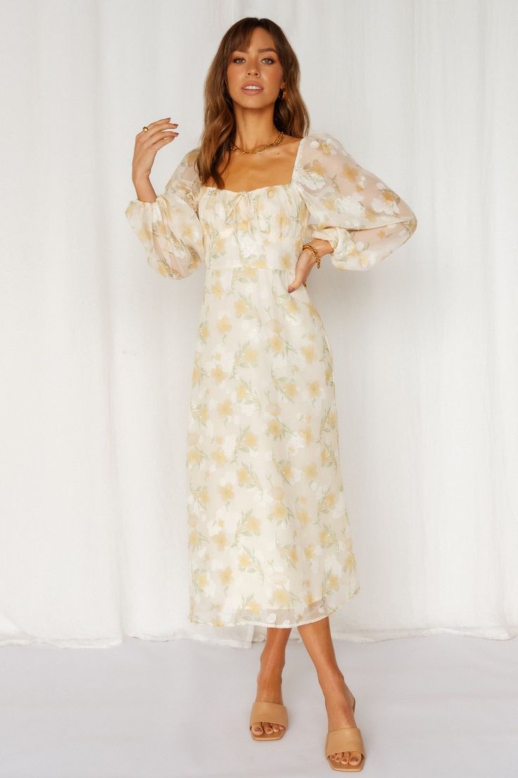 Length from shoulder to hem of size S: 117cm. Beige floral-print midi dress. Lined. Cold hand wash only. Model is a standard XS and is wearing XS. True to size. Non-stretchy, soft cotton fabric. Elasticated shirred back. Invisible back zipper. Polyester. We are here to meet all your picnic outfit dreams! The Middle Child Midi Dress is the ultimate addition to your brunch outfits. This gorgeous mid-length dress offers a milkmaid design with a dainty tie to the bust, short balloon sleeves and a long flowy skirt. Style with white sneakers and a straw hat. Picknick Outfits, The Middle Child, Picnic Outfit, Brunch Outfits, Long Flowy Skirt, Middle Child, Dress Beige, Floral Print Midi Dress, Brunch Outfit