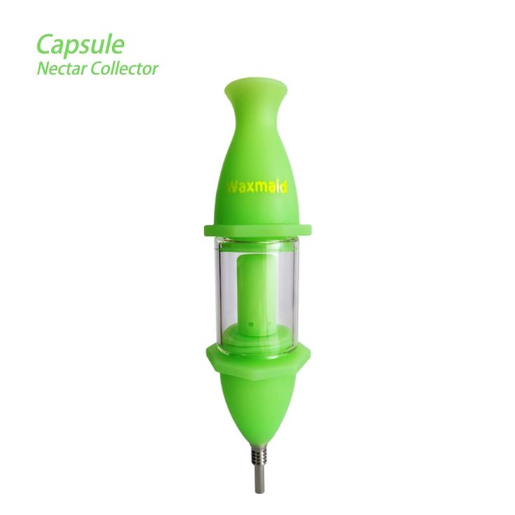 a green electric juicer sitting on top of a white surface with the caption capsule nectar collector