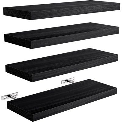 three black shelves with metal brackets on each shelf and one above the shelf is a white background