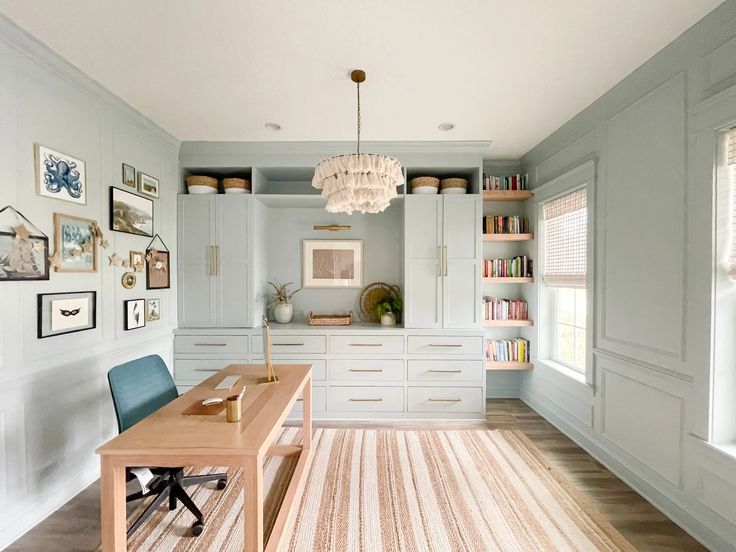 a room with a desk, chair and bookshelf on the far wall in front of it