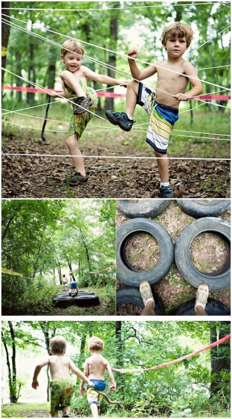 two young boys are playing in the woods and one boy is holding on to a rope