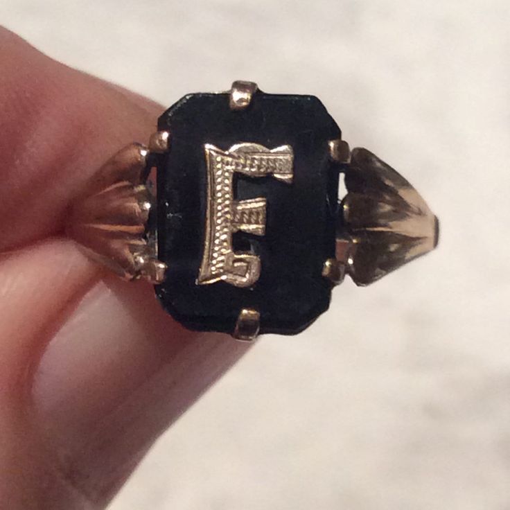 Stunning Art Deco 1920's black onyx and 9ct gold initial F  ring. Here we have an Art Deco ring with a lightly engraved gold initial F set onto black onyx. The initial F has simple gold shoulders in an openwork pattern in keeping with the clean lines of the Deco ring. The ring is in a good antique condition. The black onyx has a minor nick on the edge of  the onyx - to the left of the initial F and the usual rubs and minor scratches associated with normal use. The antique ring is marked 9c  inside the shank for 9ct gold. The onyx is firmly held in place with a claw  gold setting. The gold band is good and strong. A great statement or stand alone ring, and a lovely addition to your jewellery collection. Measures: Ring size: UK. N. 1/2.     US. just over 6 3/4                    Ring face: Black 14k Gold Engraved Jewelry, Engraved Black 14k Gold Jewelry, Engraved 14k Black Gold Jewelry, Elegant Black Monogram Jewelry, Elegant Black Initial Ring For Anniversary, Black Round Jewelry With Initials, Black Elegant Initial Ring For Anniversary, Classic Black Initial Ring For Formal Occasions, Victorian 14k Gold Signet Ring With Initials