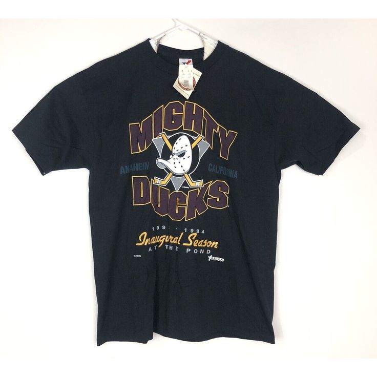 a black mighty ducks t - shirt hanging on a white wall