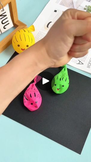 someone is holding their hand up to some cute little toy animals on top of a table