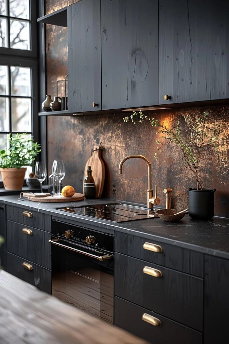 a kitchen with wooden cabinets and black counter tops, gold accents on the backsplash