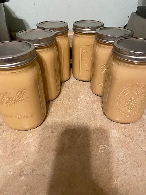 four jars are lined up on the counter