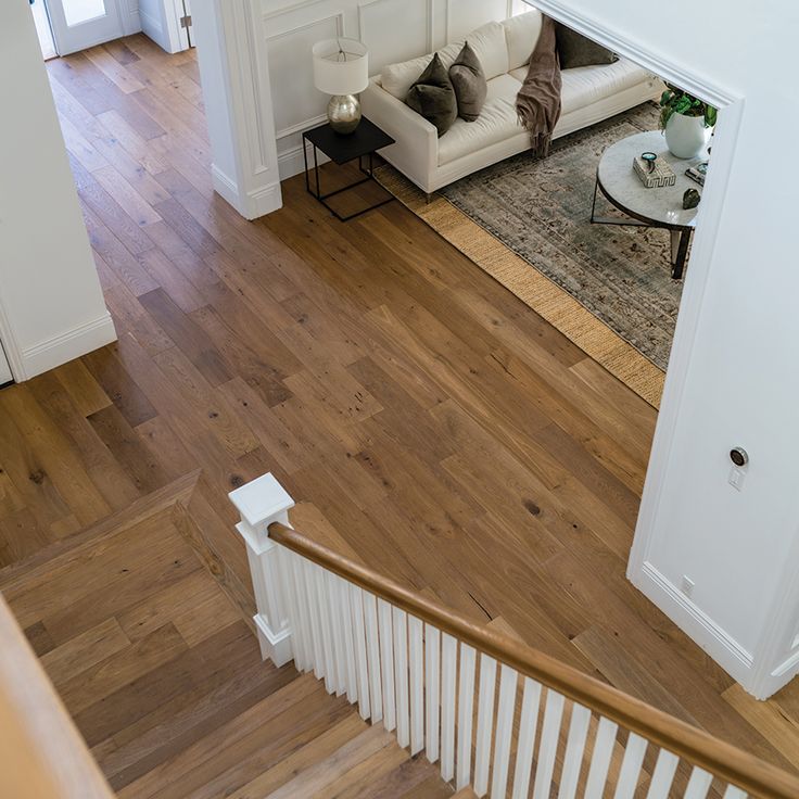 an overhead view of a living room and staircase from the top floor to the second floor