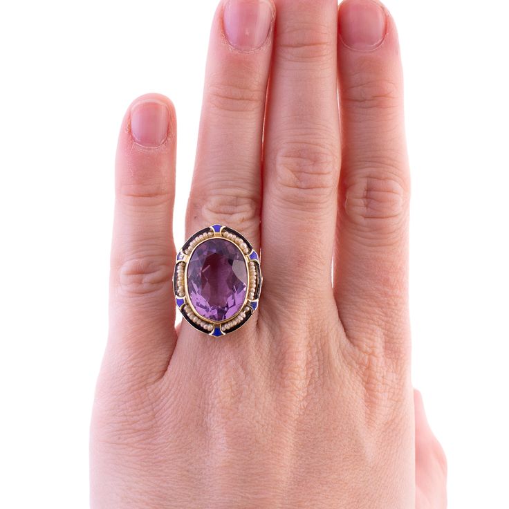 An Art Deco Cocktail Ring Amethyst and Seed Pearls 14K yellow and white gold From the 1920's The ring fits close to a size 6, pulls up about 5.25 on the ring sizer but the back is open behind the amethyst Wear consistent with the age of the piece, some enamel is chipped but otherwise in good condition 6.5 grams Antique Oval Multi-stone Ring, Fine Jewelry Open Amethyst Ring For Formal Occasions, Fine Jewelry Yellow Gold Amethyst Open Ring, Heirloom 14k Gold Amethyst Ring With Accent Stones, Victorian Amethyst Ring With Accent Stones For Formal Occasions, Art Deco Multi-stone Oval Jewelry, Heirloom 14k Stamped Amethyst Jewelry, Purple Amethyst Art Deco Ring, Art Deco Multi-stone Ring For Formal Occasions