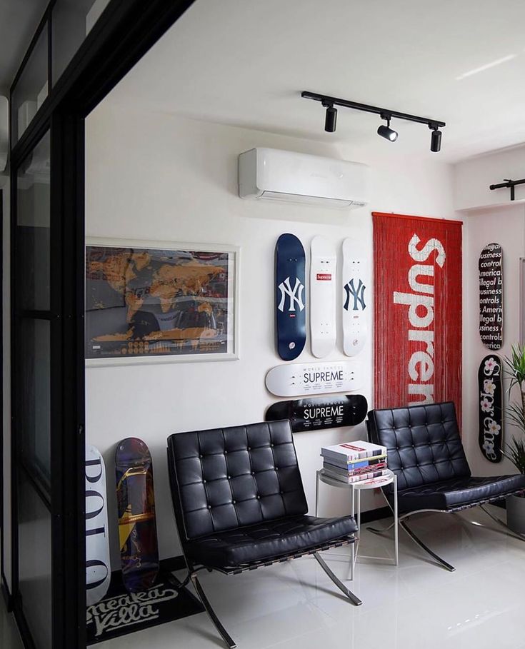 a room with two chairs and surfboards on the wall