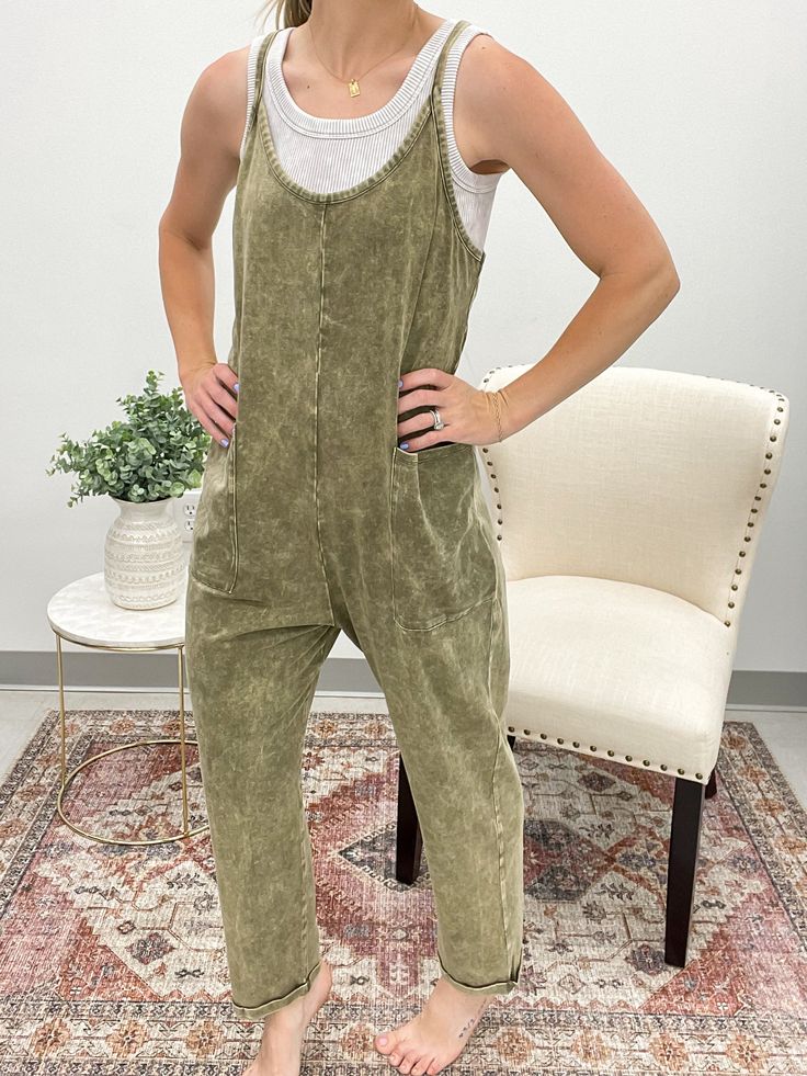 Get ready to elevate your look with our One Shot Stone Washed Jumpsuit. This harem jumpsuit features a relaxed, oversized fit for ultimate comfort, while the pockets add functionality. Perfect for a casual day out or dressing up for a night out, this jumpsuit is a versatile and stylish addition to your wardrobe. Features zipper pocket detail on back Runs true to size Model is 5’4 and wearing a small/medium Casual Overall Jumpsuits And Rompers For Loungewear, Casual Solid Color Overalls Romper, Comfortable Summer Loungewear Jumpsuits And Rompers, Comfortable Summer Loungewear Jumpsuits, Comfortable Summer Jumpsuits And Rompers For Loungewear, Comfortable Solid Jumpsuits And Rompers With Pockets, Relaxed Sleeveless Loungewear Jumpsuit, Casual Sleeveless Jumpsuits And Rompers For Lounging, Leisure Jumpsuits And Rompers With Pockets