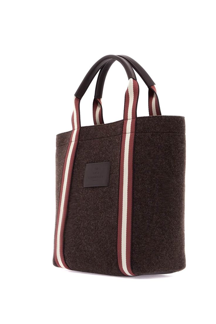 The Anya Hindmarch Pont tote bag is made from recycled wool felt with ribbon handles and eco-leather details. The tonal logo patch is applied on the front, while the interior is unlined and features a zip pocket. This stylish and sustainable bag is perfect for everyday use. Composition: 100% REC WO Daily Use Wool Bag With Leather Handles, Daily Wool Bag With Leather Handles, Daily Use Wool Bags With Leather Handles, Wool Tote Bag For Everyday Use, Wool Tote Bag For Daily Use, Daily Use Wool Tote Bag, Wool Tote Bag For Travel, Rectangular Wool Travel Bag, Rectangular Brown Wool Shoulder Bag