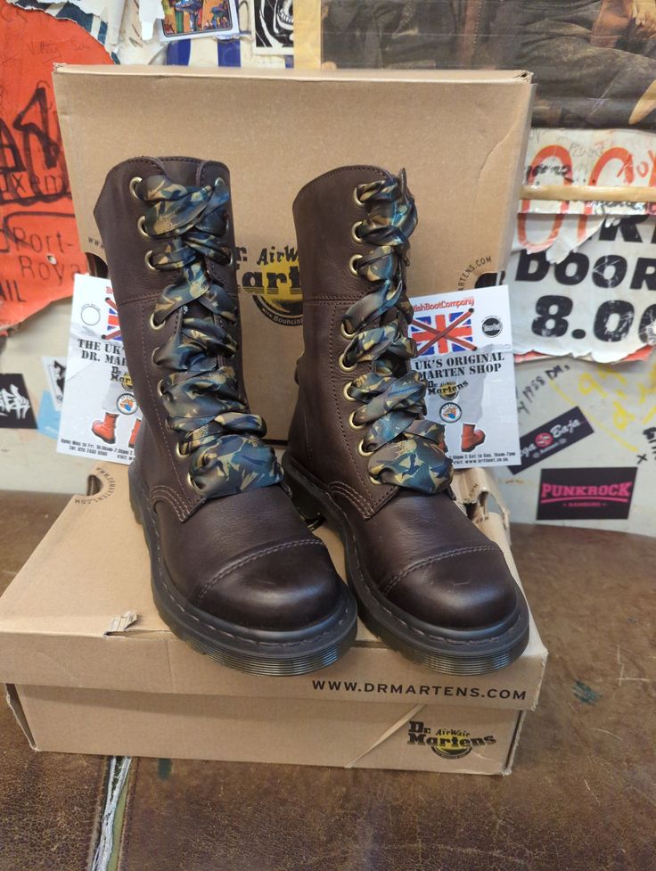 These 9 hole Dr Martens boots are a style that's no longer in production. They were part of the Triumph range, just a lower version. The boot is finished in a nice brown waxy leather. It has a stitched toe cap and camo laces matching it's interior. The boot can be folded to show it off . These are a UK size 3, European 36,ladies USA 5 Brown Lace-up Combat Boots With Rubber Sole, Brown Round Toe Moto Boots For Streetwear, Brown Steel Toe Moto Boots For Fall, Brown Moto Boots With Round Toe For Streetwear, Fall Brown Steel Toe Moto Boots, Brown Leather Desert Boots With Steel Toe, Brown Lace-up Moto Boots With Steel Toe, Brown Moto Boots For Winter Streetwear, Brown Winter Moto Boots For Streetwear