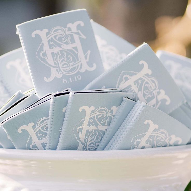 a white bowl filled with blue napkins on top of a table