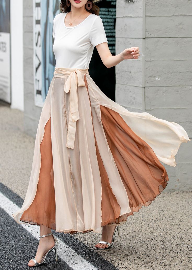 "Introducing our khaki double-layered chiffon wrap skirt. This versatile piece is perfect for adding a touch of elegance to your wardrobe. The lightweight chiffon fabric drapes beautifully, while the double-layered design adds dimension and movement. The wrap style allows for an adjustable fit. Whether you're dressing it up for a special occasion or keeping it casual with a simple top, this skirt is a must-have.  DETAILS: * Chiffon skirt * Chiffon lining * Wrap skirt * with long belt * High waistband * Circle Skirt * Perfect for spring, summer and autumn * Machine Washable in Warm/Cold Water; Do not bleach / Mid-iron / Hang Dry * Great for Daily Wear/Wedding/Bridesmaid Dresses/Vacation/Date Night/Graduation Ceremony/Party etc * The model is 170 cm (5' 7\") tall with 85 cm(33.4\") bust and Flowy Beige Midi Skirt, Beige Flowy Maxi Skirt With Lining, Flowy Beige Chiffon Skirt, Long Beige Chiffon Skirt, Beige Long Chiffon Skirt, Elegant Beige Chiffon Skirt, Skirt Movement, Long Layered Skirt, Skirt And Top Outfits