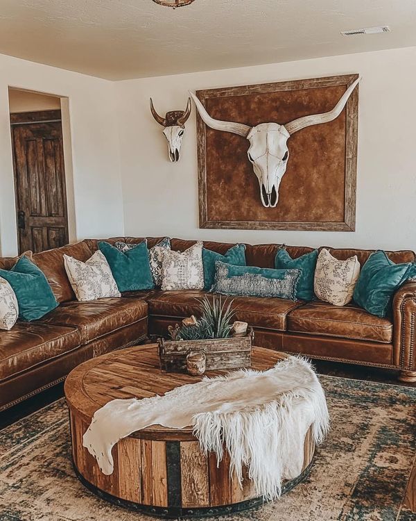 a living room filled with furniture and a cow skull mounted on the wall above it