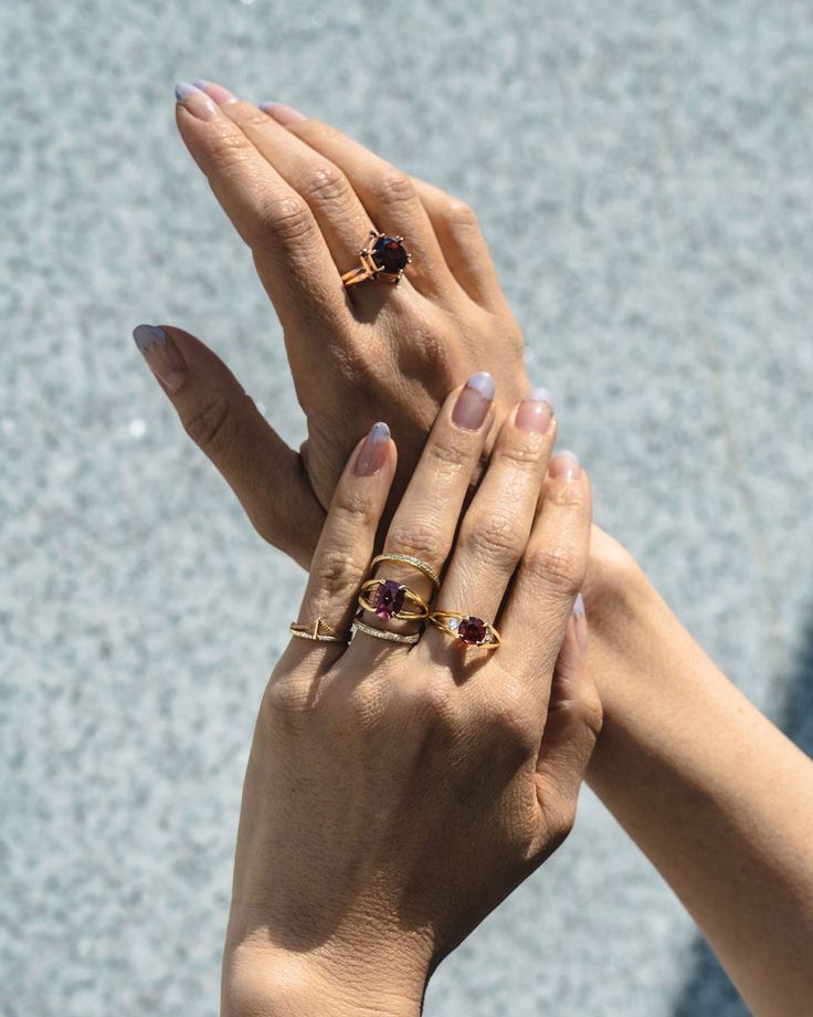 Designed for the forward thinking and fearless. Experimental and beautiful, this new iteration of our signature Futurist Ring is dedicated to the independent and loved, each side stone representing the trusted people by your side. Features G-VS quality lab grown diamond pave and side stones, 0.2 total carat weight Malaya Garnet Center Stone, 1.69ct 8mm Ring measures 4.6mm above the finger, 1.65mm thick around the finger Available in Recycled or Fairmined gold Made in Yellow Gold, White Gold, Ros Malaya Garnet, Sustainable Jewelry, Platinum Ring, Three Stone Rings, Recycled Gold, Red Garnet, Three Stone, Black Diamond, Pave Diamonds