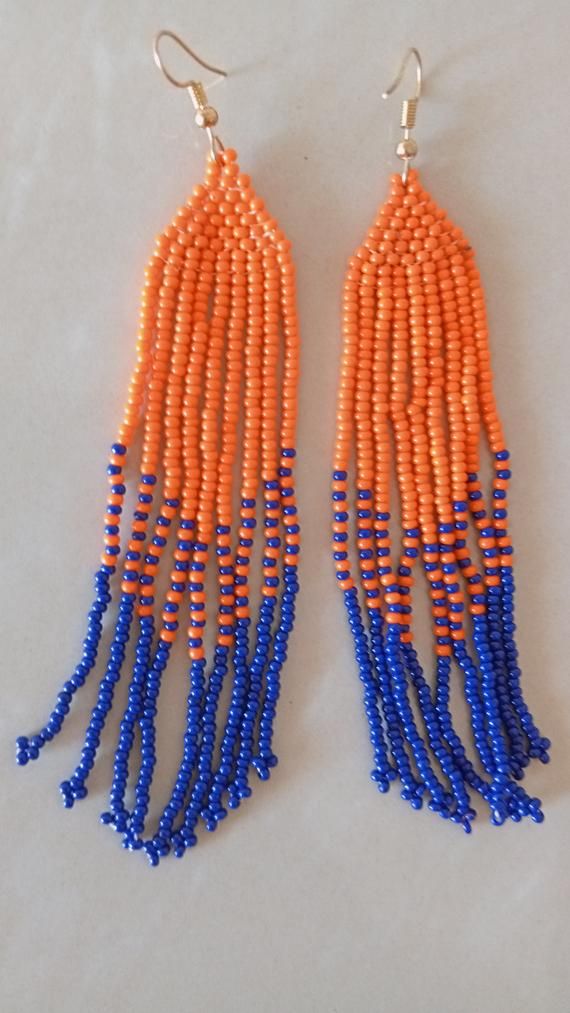 African beaded earrings, Handmade earrings, African jewelry, Maasai jewelry, Earrings for women,Gift for her, Tribal EarringsThese stunning earring are superbly crafted which will absolutely makes stand out in any occasion.Color - Blue and Orange.3-5 days delivery via DHL ExpressThe shipping fee is for the first item only and additional necklaces or items ship for free.Wholesale available at a fair price,please contact me.For any clarification,please send me a convo or an e-mail.Thank you for vi Traditional Long Drop Beaded Earrings With Dangling Beads, Traditional Long Drop Beaded Earrings, Traditional Tassel Earrings With Round Beads, Traditional Beaded Dangle Earrings, Traditional Beaded Dangle Danglers, Traditional Beaded Danglers, Traditional Chandelier Earrings With Round Beads, Beaded Dangle Danglers For Festivals, Maasai Jewelry