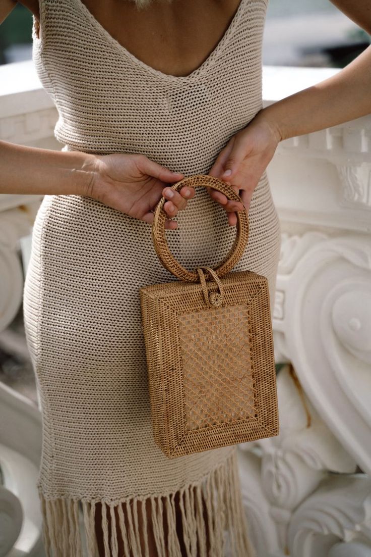 This basket bag was handwoven by a weaving artisan co-op in Bali, Indonesia, using locally sourced, renewable resources. This bag takes six weeks to weave, dry, and finish. Handles: Organic ata grass Body: Organic ata grass Lining: Organic 100% cotton canvas / Cream Dimensions 5.9 “ L x 2.3 “ W x 8.3 “ H / 15 cm L x 6 cm W x 21 cm H Natural Woven Crochet Top Handle Bag, Eco-friendly Woven Bucket Bag With Top Handle, Everyday Handwoven Straw Bag With Top Handle, Top Handle Woven Rattan Bag, Rectangular Rattan Straw Bag With Open Weave, Woven Rattan Top Handle Bag, Rectangular Woven Rattan Bags, Woven Jute Rectangular Bucket Bag, Beige Rectangular Crochet Bag With Bamboo Handle