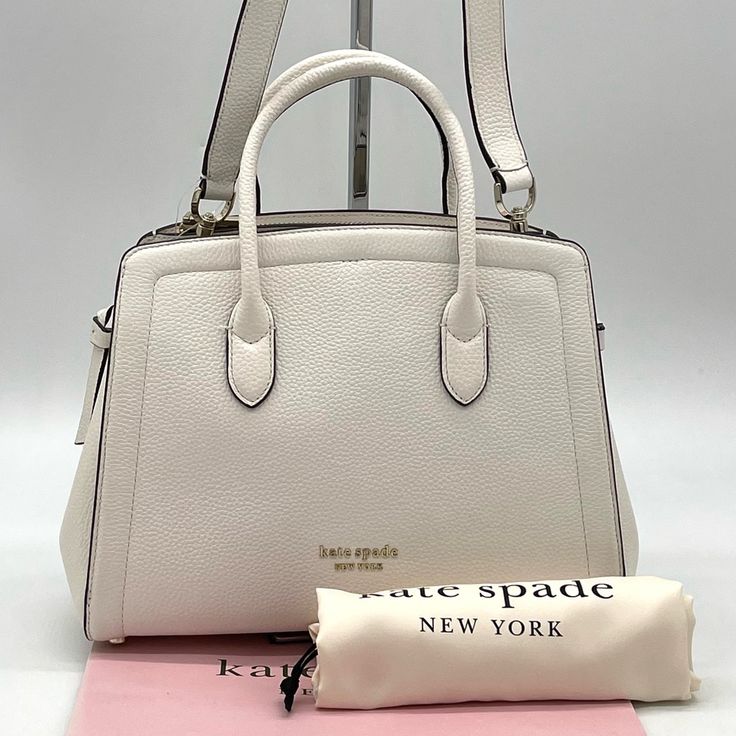 Brand New With Tag Kate Spade Knott Medium Satchel Crossbody Bag Not Outlet Style 8.25"H X 11.25"W 4.75"D Handle Drop: 3.75" Strap Drop: 22" Pebbled Leather With Smooth Italian Leather Trim Textured Pvc Lining Pinmount Logo Satchel With Open Top And Dog-Clip Closure Interior Snap-Tab Slip Pocket Interior Zipper Pocket Optional (And Adjustable) Crossbody Strap Pale Gold-Tone Hardware Fits Current Iphone, Large Continental Wallet, Ipad Imported Chic White Satchel With Top Carry Handle, Chic White Satchel With Handles, White Formal Satchel With Detachable Handle, Classic White Satchel For Formal Occasions, Classic White Satchel For Travel, Designer White Satchel With Top Carry Handle, Designer White Satchel With Top Handle, Classic White Bags With Detachable Handle, Designer White Top Handle Satchel