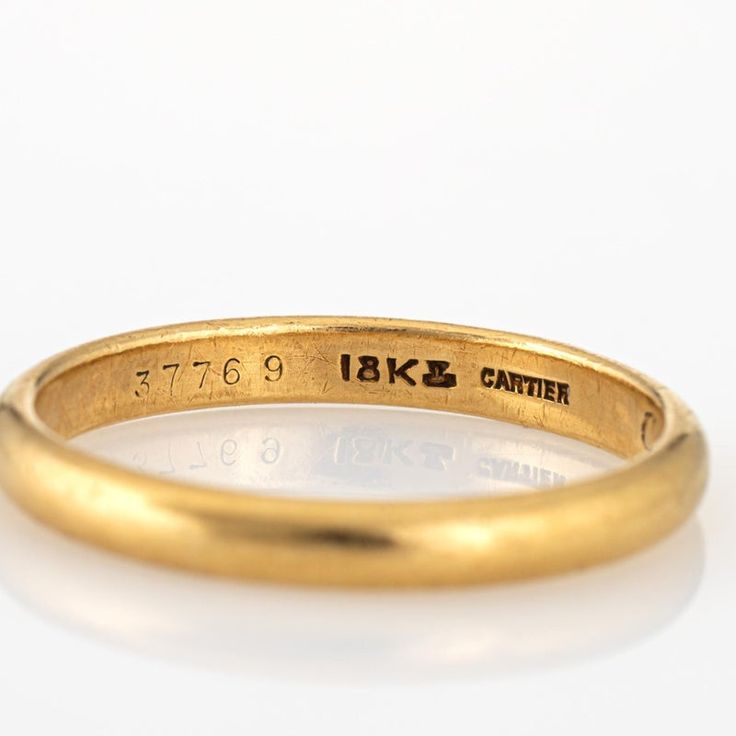 a close up of a gold ring on a white surface with the words, 17k and canter