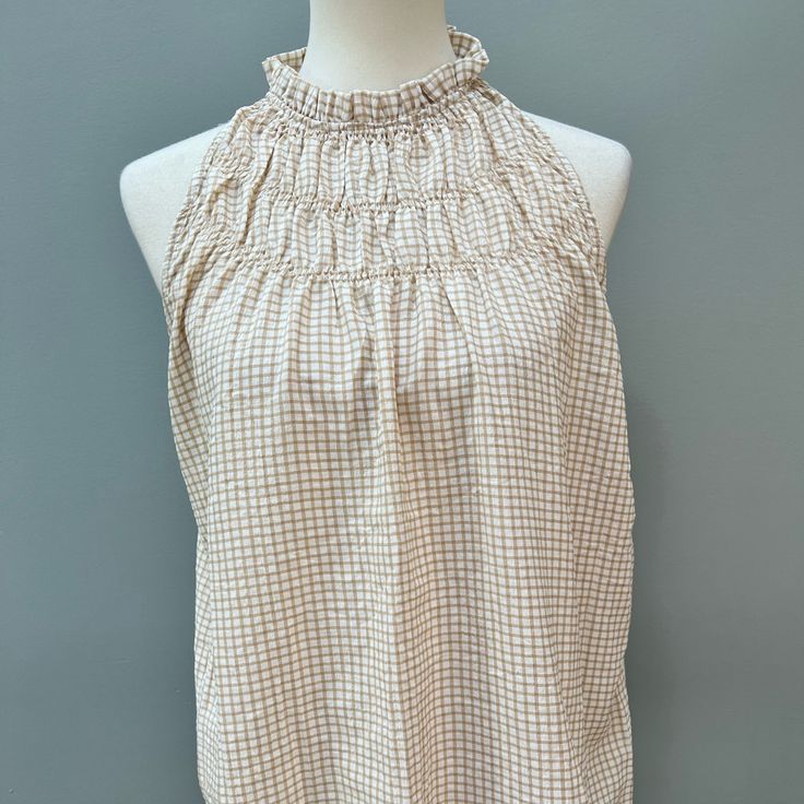 Size Medium Sleeveless Blouse. Smocked Details At Neckline Make This A Cute Option To Wear With Shorts Or Jeans. Neutral Color That Will Compliment Most Other Colors. Msrp: $58.00 Chic Beige Sleeveless Halter Top, Casual Ruffled Halter Neck Top, Chic Sleeveless Smocked Top With Elastic Neckline, Sleeveless Tops With Elastic Neckline For Summer, Sleeveless Tops With Elastic Neckline For Vacation, Feminine Ruffled Sleeveless Halter Top, Spring Sleeveless Tops With Elastic Neckline, Summer Halter Neck Top With Smocked Back, White Smocked Bodice Tank Top