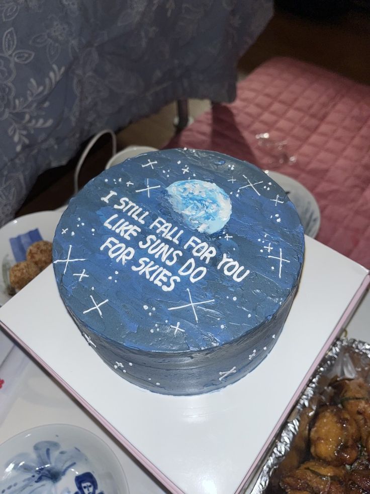 a picture of a custom made cake with deep blue icing resembling space with blue/white/sky blue icing in the middle representing the earth. white icing mark stars all over the cake's surface and it says 'i still fall for you like suns do for skies' in white lettering on the top. Starset Tattoo, Honkai Oc, Music Birthday Cake, Dustin Bates, Cake Song, Green Birthday Cakes, Still Falling For You, Cake Quotes, Green Birthday