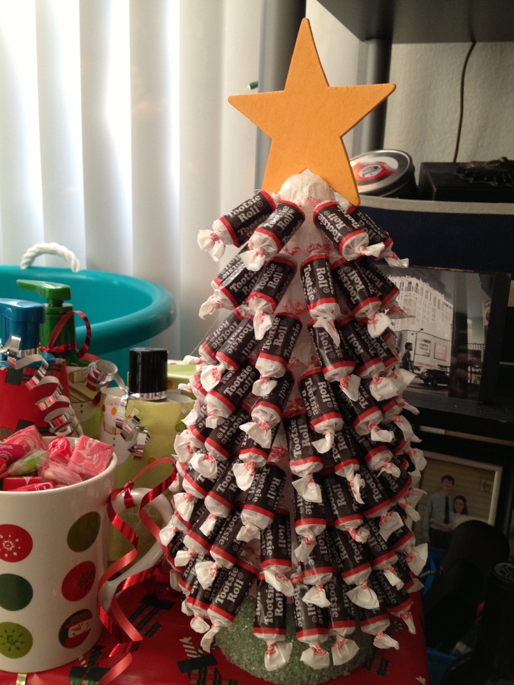 a christmas tree made out of chocolate bars and candy wrappers with a star on top