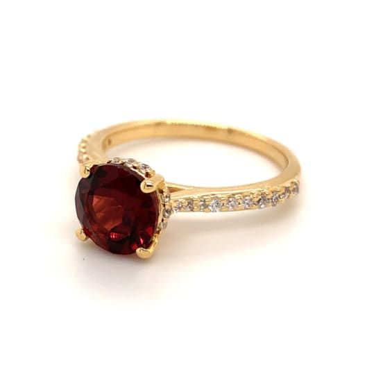 2.30ct round garnet and cubic zirconia 14k yellow gold over sterling silver ring. Fine Jewelry Ruby Ring With Pave Setting, Round Ruby Ring With Pave Setting For Gift, Red Pave Setting Rings, Classic Ruby Ring With Pave Setting, Red Rings With Pave Setting, Gift Ruby Ring With Pave Setting, Yellow Gold Garnet Jewelry With Round Cut, Round Ruby Ring With Vvs Clarity Cubic Zirconia, Yellow Gold Ruby Ring With Cubic Zirconia