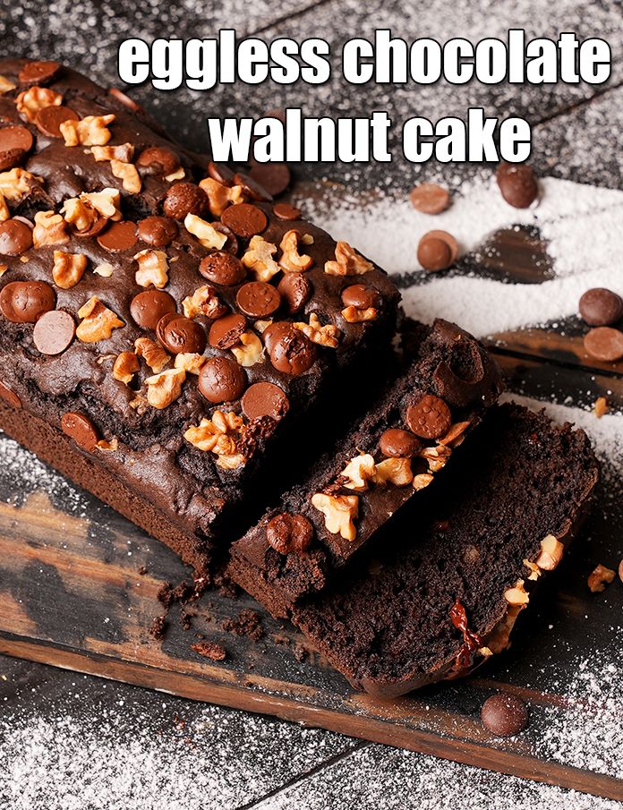 two pieces of chocolate walnut cake on a cutting board