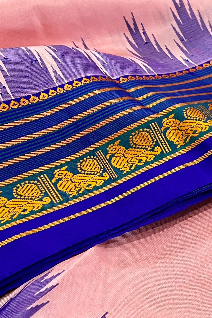 Fabric : Pure Kanjivaram Silk Type : Thread work korvai contrast Body Color : Light lotus pink Border Color : Bluish purple Blouse Color: Bluish purple Pallu Color: Bluish purple Approximate height - 46 - 52" Approximate weight - 1.4 lbs Approximate Length - 6.25 - 6.50 mtrs (inclusive of blouse length) Technique on the blouse : Aari and mirror work Saree comes with fall, picot and tassels done when applicable. Blouse piece is cut. Kindly Note : The colors you see on your device may vary due to Mirror Work Saree, Purple Blouse, Silk Cotton Sarees, Work Sarees, Mirror Work, Thread Work, Blouse Length, Body Colour, Blouse Piece