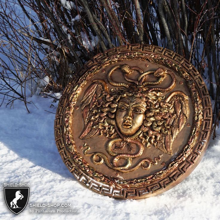 a metal plaque with an image of a woman's face on it in the snow