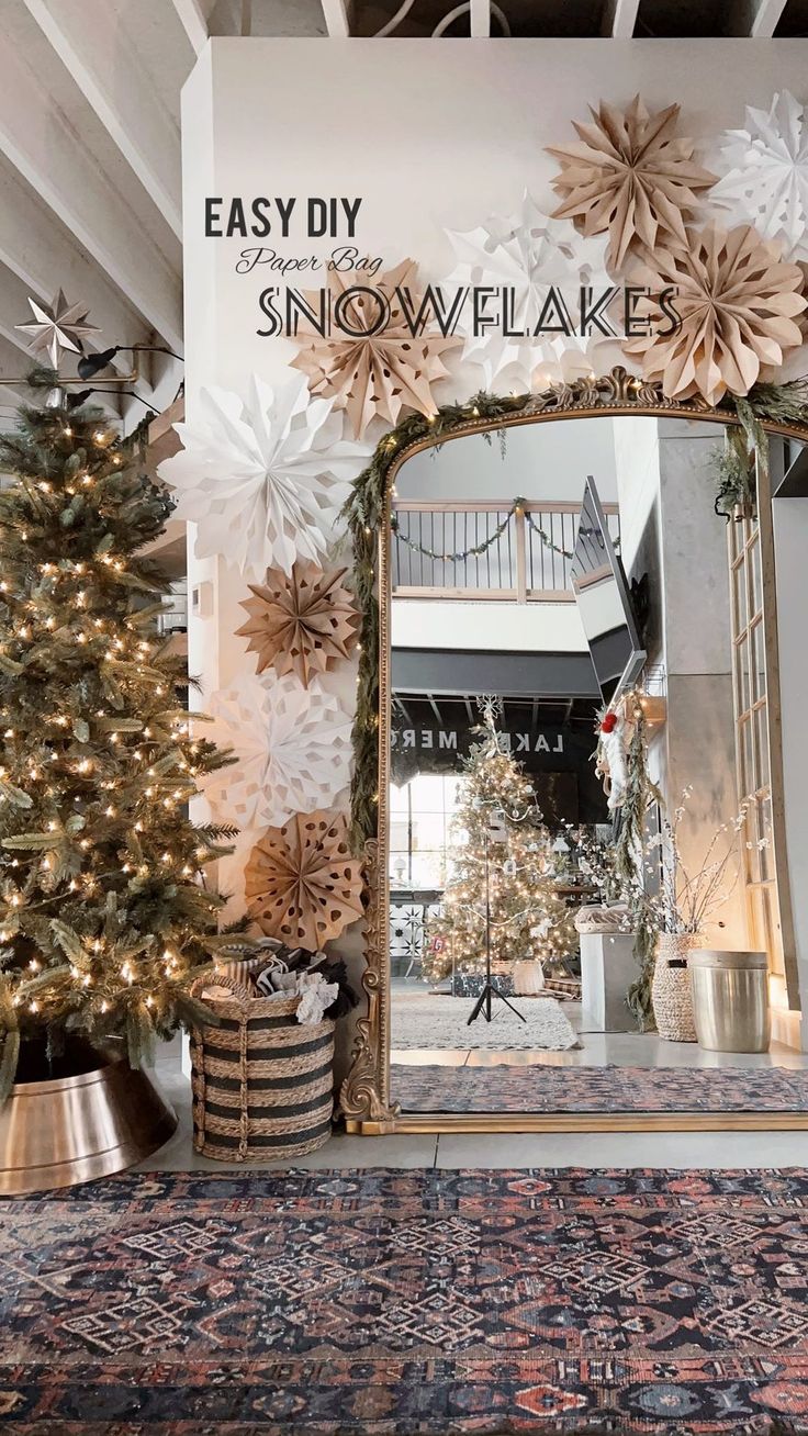 a decorated christmas tree sitting in front of a mirror with snowflakes on it