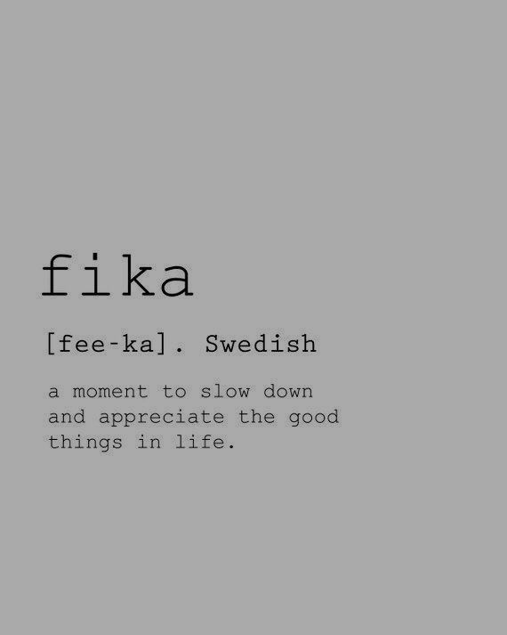 the words fika are written in black and white on a gray background with an image of