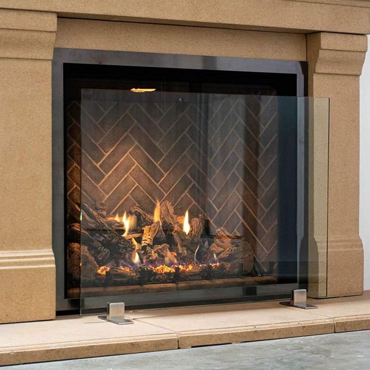 a fireplace with a fire in it sitting next to a wall