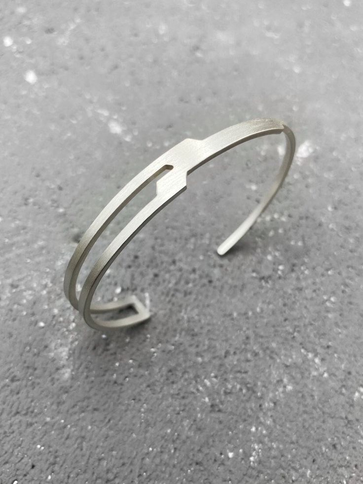 The aesthetics of this cuff bracelet are striking and distinct, as the sharp angles create a captivating visual impact. The edginess of the design adds a touch of attitude and character while the use of sterling silver reflects a subtle luxury. It is a versatile accessory complementing a wide range of personal styles and outfits, while its form allows for a comfortable fit and easy adjustment, making it suitable for various wrist sizes. It is part of my first silver jewelry collection "IN STORM" Modern Cuff Jewelry For Everyday, Modern Adjustable Sterling Silver Bangle Bracelet, Modern Adjustable Sterling Silver Bangle, Modern Adjustable Open Band Bracelets, Adjustable Modern Open Band Bracelets, Modern Adjustable Open Band Bracelet, Adjustable Sterling Silver Chain Bracelet, Modern Adjustable Sterling Silver Bracelet, Adjustable Modern Sterling Silver Bracelet