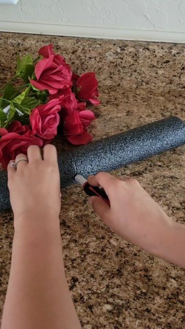 a woman is arranging flowers on the counter