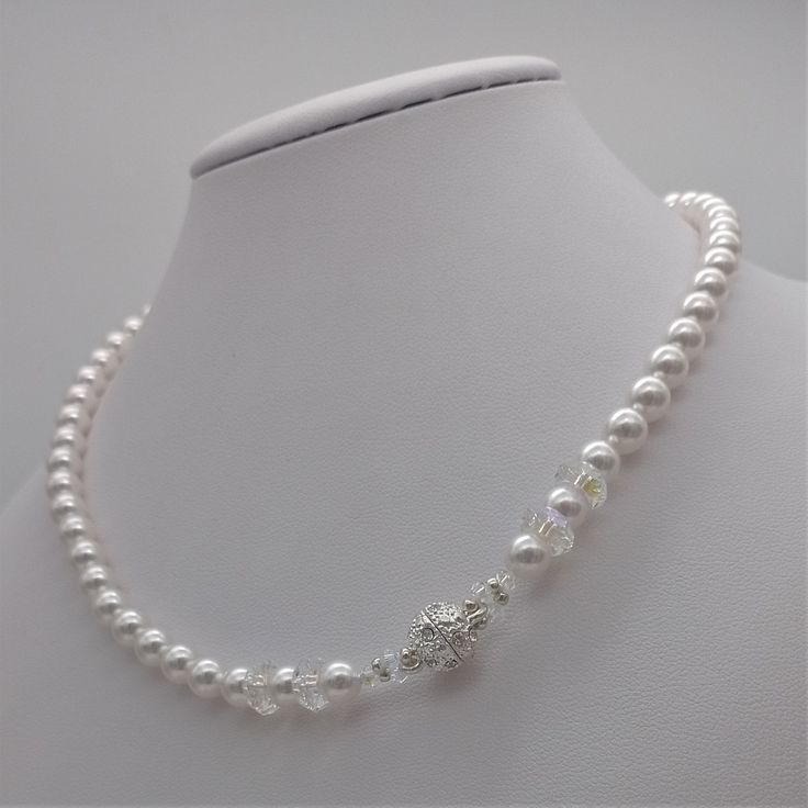 This beautiful choker necklace is handmade with 6mm white Swarovski pearls. It's adorned with 8mm Swarovski rondelle detailing and a magnetic closure with crystals that make it particularly sumptuous. It's a classic necklace that never goes out of style. A luxurious accessory for an elegant occasion. The necklace will be delivered in its case, ready to be gifted. Matching earrings and a bracelet are available. For ideas or alternatives, feel free to contact me. Elegant White Crystal Necklace With Pearl Chain, Elegant White Crystal Necklaces With Pearl Drop, Elegant Pearl Crystal Necklace With Round Beads, Elegant White Crystal Necklace With Pearl Drop, Elegant Adjustable Crystal Necklace With Pearl Chain, Elegant Adjustable Pearl Chain Crystal Necklace, White Crystal Necklaces With Pearl Drop As Gift, Gift White Crystal Necklace With Pearl Drop, White Crystal Necklace With Pearl Drop As Gift