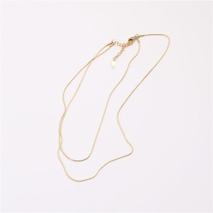 Adorn yourself in chic sophistication with our Double Layered Necklace. Crafted for style and versatility, this piece effortlessly elevates your look. Embrace the modern trend of layered elegance with this exquisite accessory. Elegant Metal Layered Necklace For Party, Minimalist Long Layered Clavicle Necklace, Minimalist Layered Long Necklace With Clavicle Chain, Minimalist Adjustable Layered Clavicle Necklace, Elegant Double Strand Metal Layered Necklace, Minimalist Multi-strand Metal Layered Necklace, Adjustable Minimalist Multi-strand Layered Necklace, Layered Minimalist Metal Jewelry, Minimalist Layered Necklace With Adjustable Delicate Chain