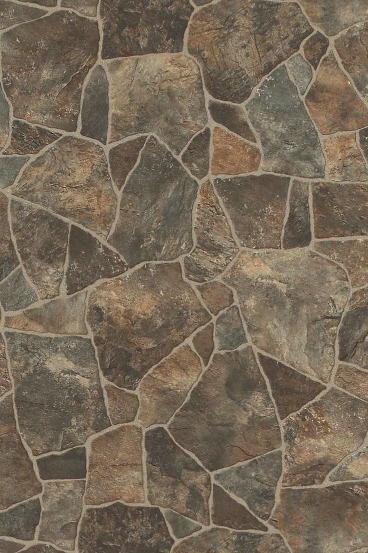 a close up view of a stone floor with brown and tan colors on the surface