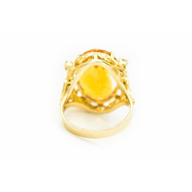 Gorgeous yellow orange color oval faceted citrine accented with 4 prong set approximate size .08 carat diamonds and six 3 prong set approximate .02 carats diamonds. Approximate total weight in diamonds is .44 carats. The sides have open scroll design that resembles a heart.  The citrine measures 13.5mm x 8.5mm.  The ring is 10k yellow gold. US size 8.5.  It can be sized.  The ring measures .76" wide by .86" tall by .36" deep. Oval Yellow Sapphire Diamond Ring Fine Jewelry, Yellow Sapphire Oval Diamond Ring, Classic Yellow Sapphire Oval Rings, Yellow Gold Citrine Oval Diamond Ring, Yellow Gold Citrine Diamond Ring With Accents, Yellow Gold Diamond Ring With Citrine Accents, Yellow Oval Topaz Ring In 14k Gold, Oval Yellow Topaz Ring In 14k Gold, Oval Citrine Diamond Ring In Yellow Gold