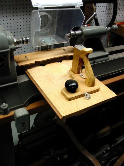 a machine that is sitting on top of a wooden table next to other machines and tools