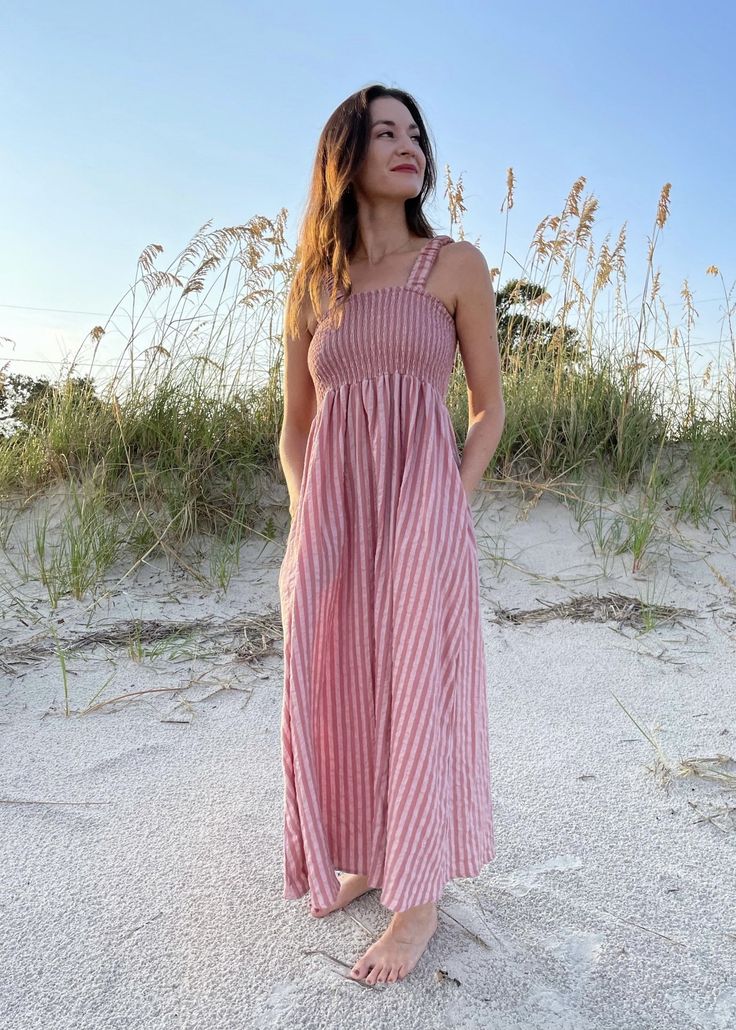 Striped Mauve Smocked Cotton Dress Crushing on this dress! So comfortable and easy to wear. It's lightweight so perfect for end of summer & a great transition color into early fall. Not to mention it has pockets! Product Details: Color: Mauve Striped Smocking detail Tank style dress Side pockets Cropped ankle length Fitted top Easy to wear, comfy Runs true to size, 5'4 wearing a small 100% Cotton Cotton Midi Dress With Smocked Back For Casual Wear, Cotton Smocked Dress For Day Out, Summer Ruched Dress For Picnic, Casual Cotton Midi Dress With Smocked Back, Casual Cotton Dress With Smocked Back, Casual Cotton Dresses With Gathered Waist, Casual Maxi Dress With Pockets For Vacation, Casual Cotton Sundress With Smocked Back, Cotton Sundress With Smocked Back For Casual Occasions