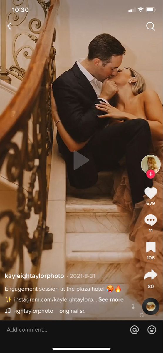 a man and woman are sitting on the stairs kissing in front of each other with their arms around each other