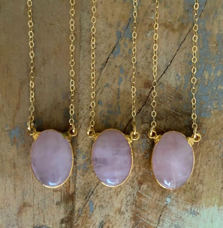 "Stunning Rose Quartz Necklace. Pendant is 24k gold plated just around the edges so you can soak in the crystal vibes💕 Chain is 18\" gold fill and can be adjusted to 16\" or 17\". Beautiful on its own or layered with your other favorites 💎 About the crystals: All crystals and gemstones are carefully chosen by myself from several vendors I have come to know over the years. I absolutely love crystals and their healing qualities as well as their beauty. My intention is to create a beautiful piece Gold Rose Quartz Crystal Necklaces, Gold Rose Quartz Round Pendant Necklace, Gold Rose Quartz Gemstone Crystal Necklace, Gold Rose Quartz Crystal Necklace, Gold Crystal Necklace With Rose Quartz Gemstone, Adjustable Gold Rose Quartz Crystal Necklace, Handmade Gold Crystal Necklace With Rose Quartz, Gold Oval Crystal Necklace For Gift, Oval Gold Crystal Necklace For Gift