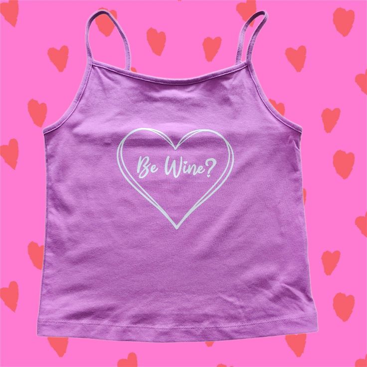 Be Wine Valentine's Crop Top Tank Top in Silver or Gold on Lavender Pink Original design; shirt color is a dusty rose / lavender pink-ish color.  Junior fit crop top Metallic Vinyl on 57% Cotton / 38% Recycled Polyester / 5% Spandex Wash on cold with like color Lay flat to dry Trendy Purple Cropped Top, Trendy Cropped Purple Tops, Trendy Purple Sleeveless Top, Lavender Sleeveless Cotton Top, Sleeveless Lavender Cotton Top, Summer Lavender Tops With Graphic Print, Lavender Graphic Print Tops For Summer, Lavender Tops With Graphic Print For Summer, Purple Y2k Tank Top For Spring