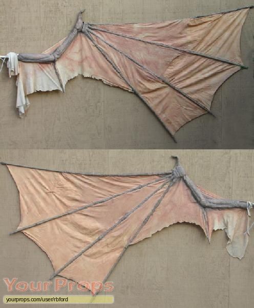 two pictures of a bat hanging on the side of a building, one with wings folded over it