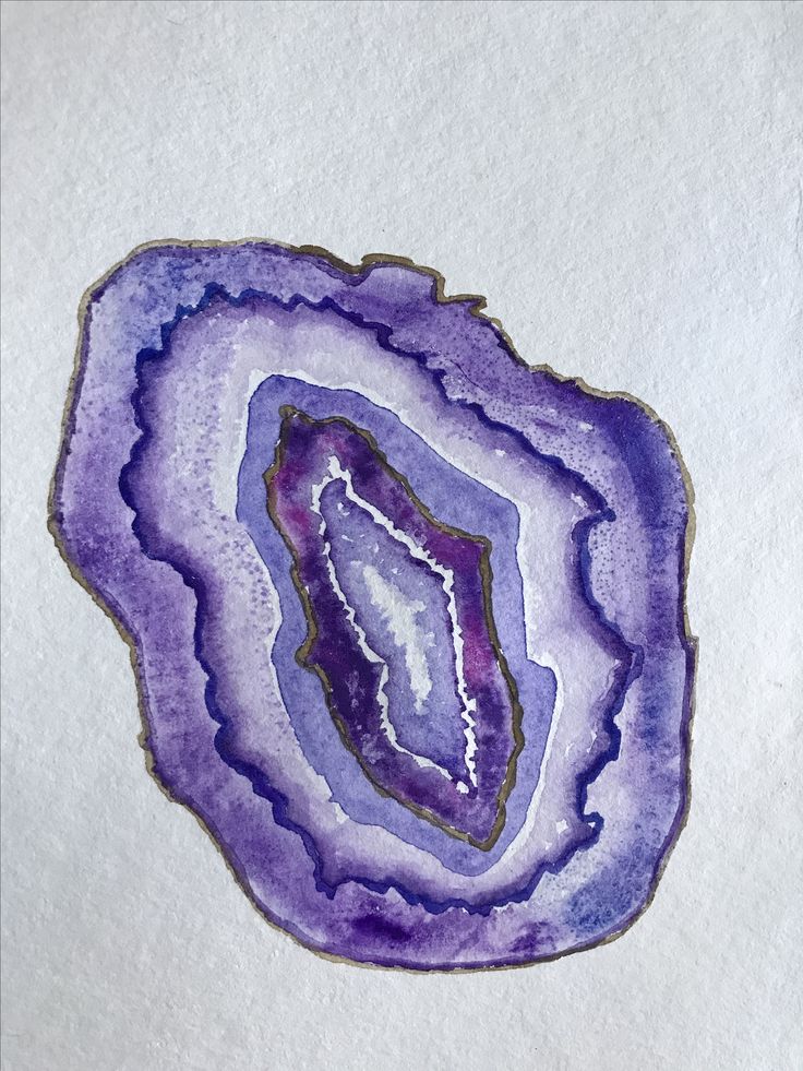 a piece of art that looks like an agate slice on white paper with blue and purple colors